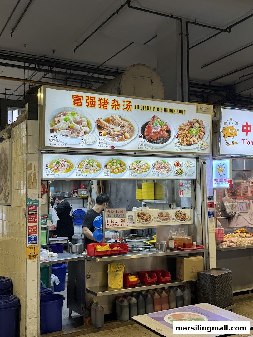 A bustling hawker stall, 'Fu Qiang Pig's Organ Soup', with a vibrant menu board and staff preparing food.