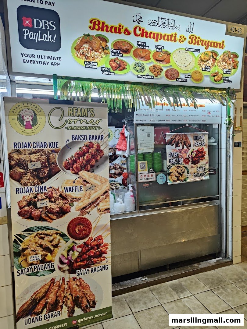 The vibrant front of two hawker stalls, Bhai's Chapati & Biryani and Rfam's Corner.