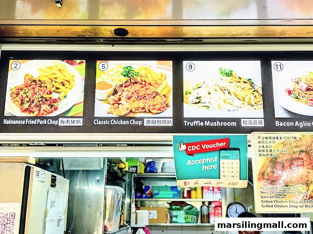 A food stall's menu board displaying various Western and pasta dishes with images.