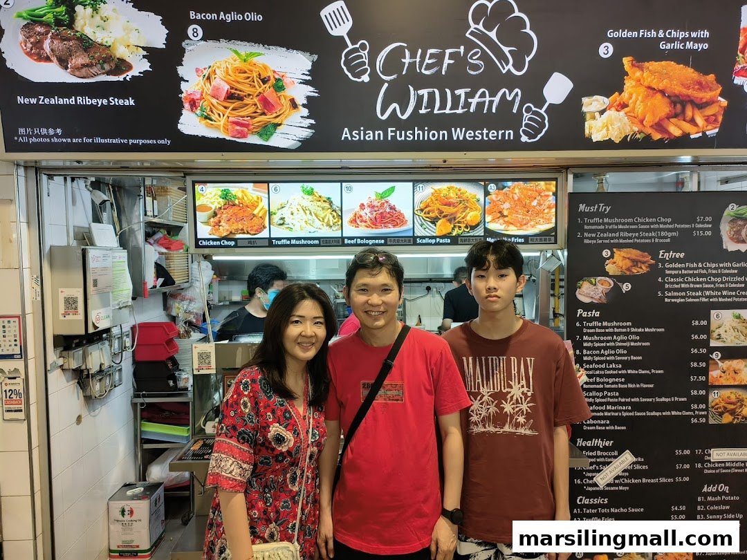A family poses in front of Chef's William's menu board, showcasing Asian fusion Western dishes.