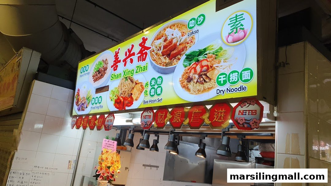 An illuminated hawker stall signboard showcasing various noodle and rice dishes at Marsiling Mall Hawker Centre.