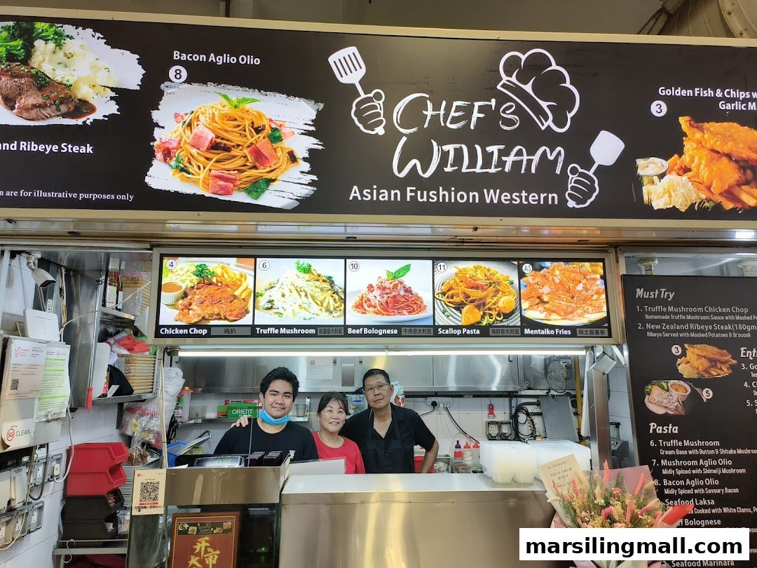 Three staff members stand behind the counter of Chef's William, an Asian Fusion Western hawker stall.