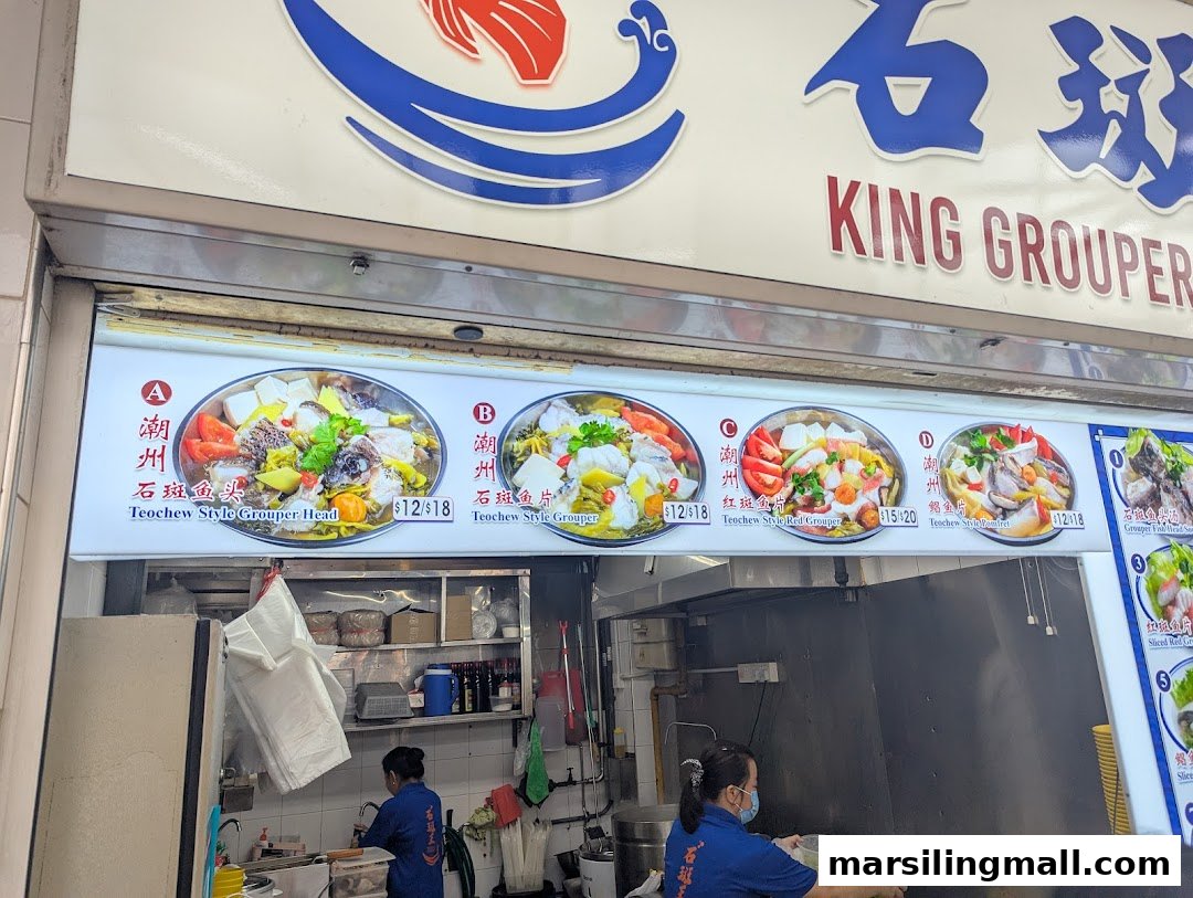 A hawker stall named King Grouper showcasing Teochew-style fish dishes with prices and staff.
