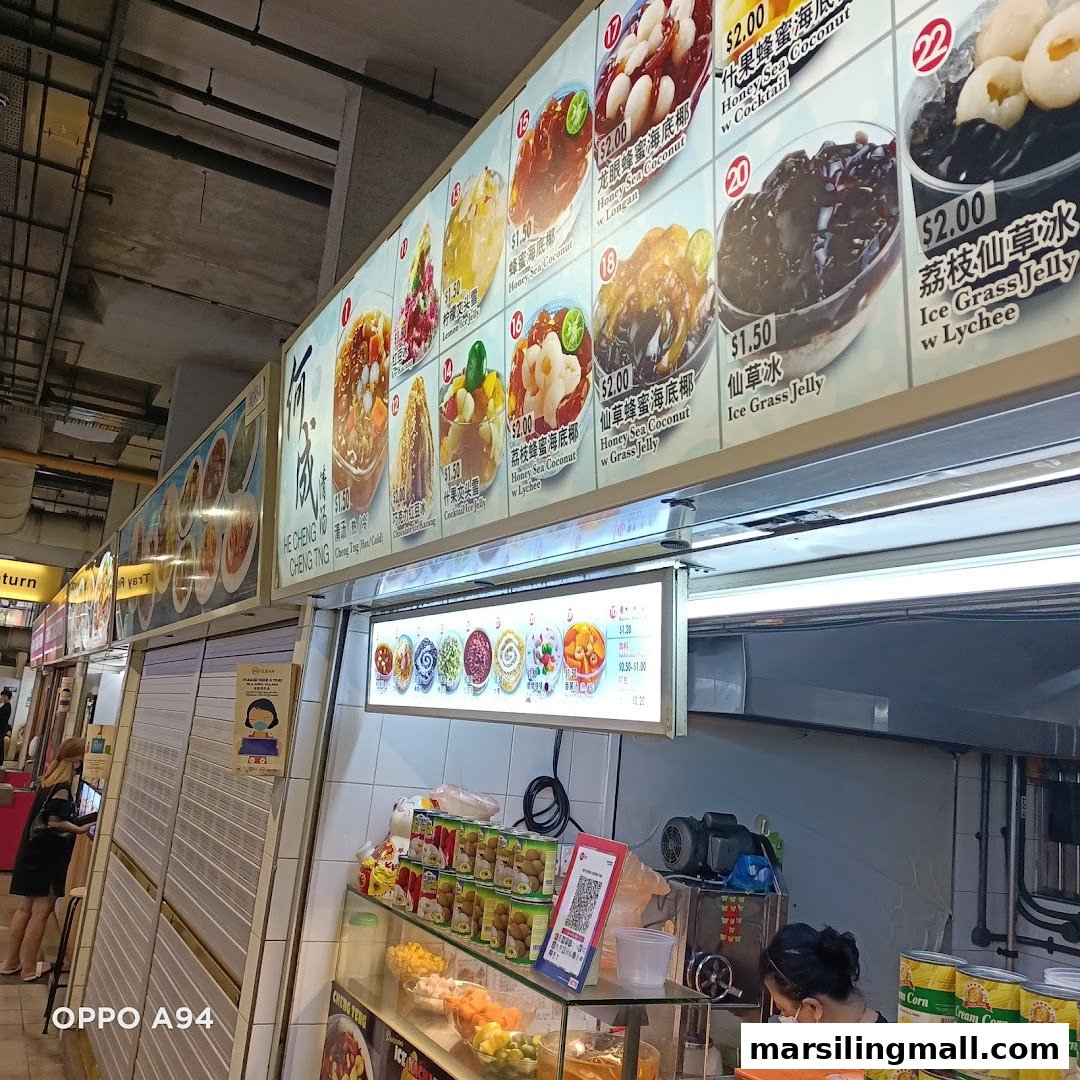A dessert stall's menu board displaying various refreshing sweet treats and prices.