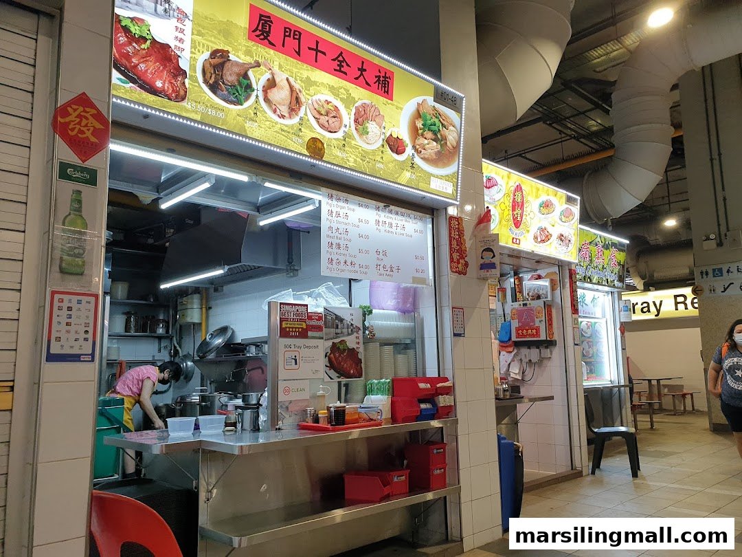 A hawker stall displaying its menu board with various traditional Chinese dishes and prices.