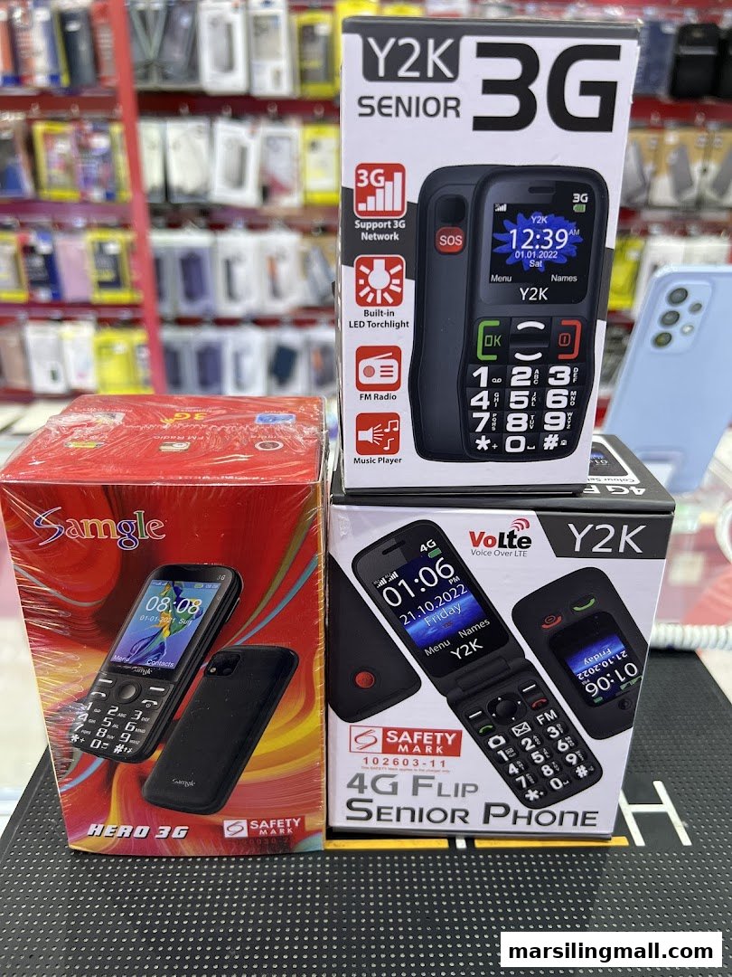 Close-up of various mobile phone boxes, including Y2K Senior and Samgle Hero 3G models, displayed in a retail store.