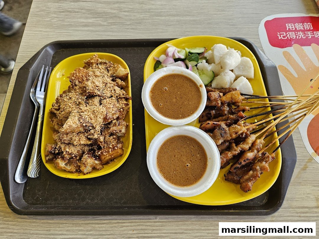 A delicious spread of satay skewers with peanut sauce and rojak topped with crushed peanuts.
