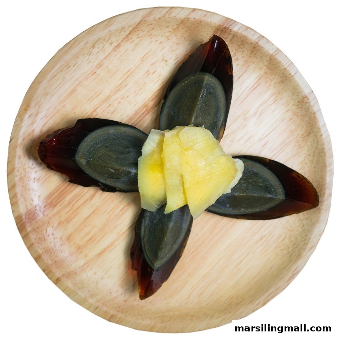 A traditional dish of sliced century eggs with pickled ginger, served on a wooden plate.