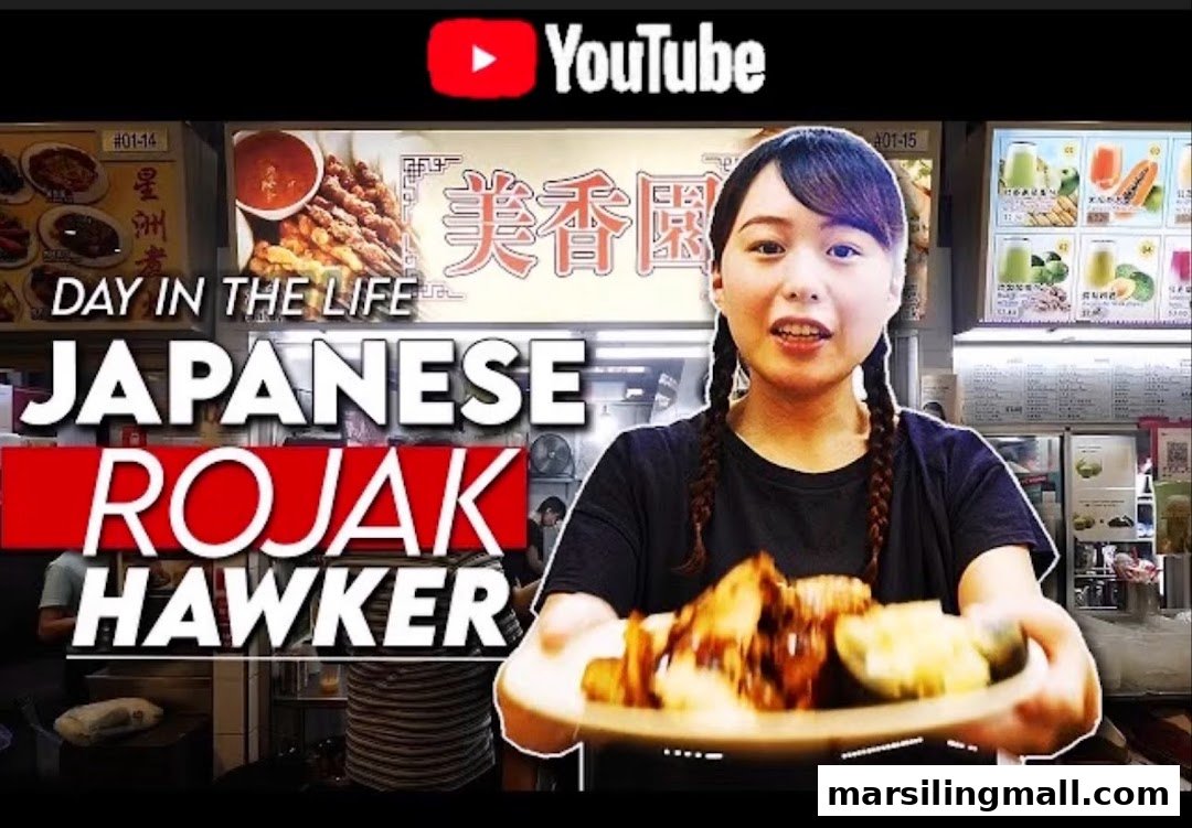 A person holds a plate of rojak in front of the 'Mei Xiang Yuan' food stall, likely a video thumbnail.