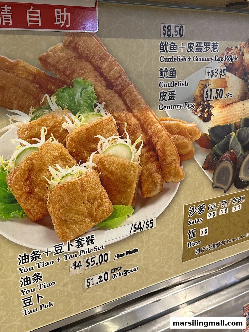 A close-up of a menu board displaying various rojak dishes, satay, and their prices.
