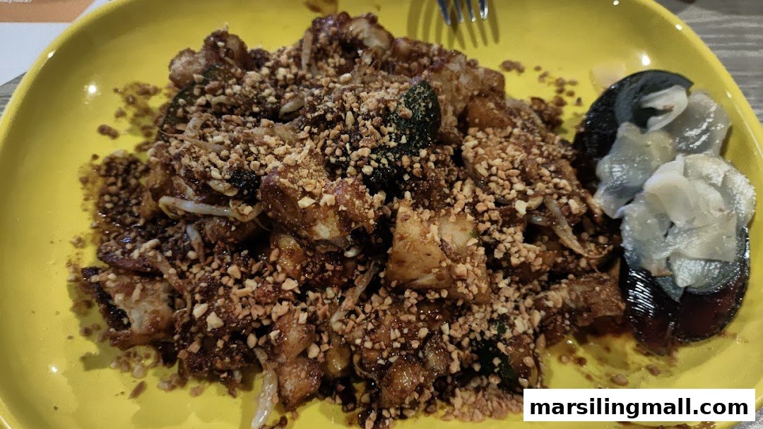 A vibrant plate of rojak, generously topped with crushed peanuts and served with century egg.