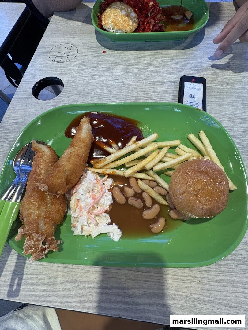 A hearty Western meal featuring fried fish, french fries, coleslaw, and baked beans on a green plate.
