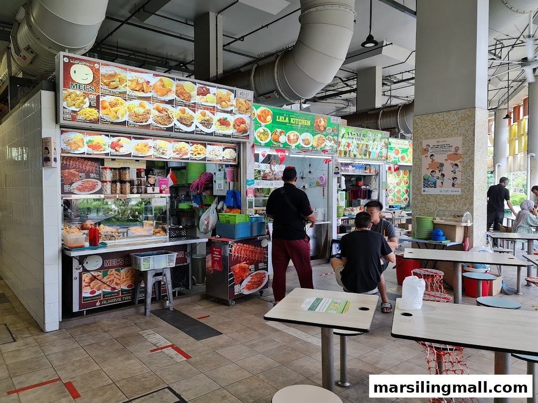 A bustling food stall named Mel's Western in a vibrant food court, featuring diverse menu options.