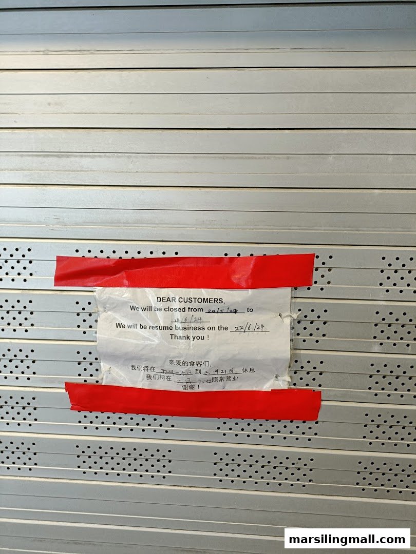 A temporary closure notice is taped to the shuttered front of Pin Wei Xiao Long Bao.