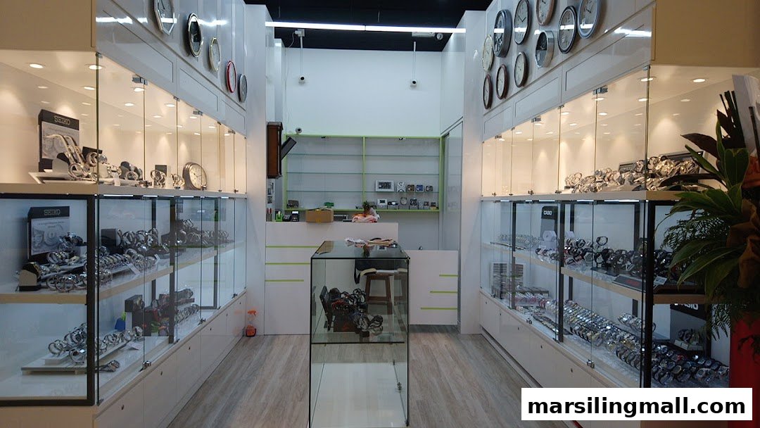 Interior view of See Toi watches shop, showcasing numerous timepieces in illuminated glass display cases.