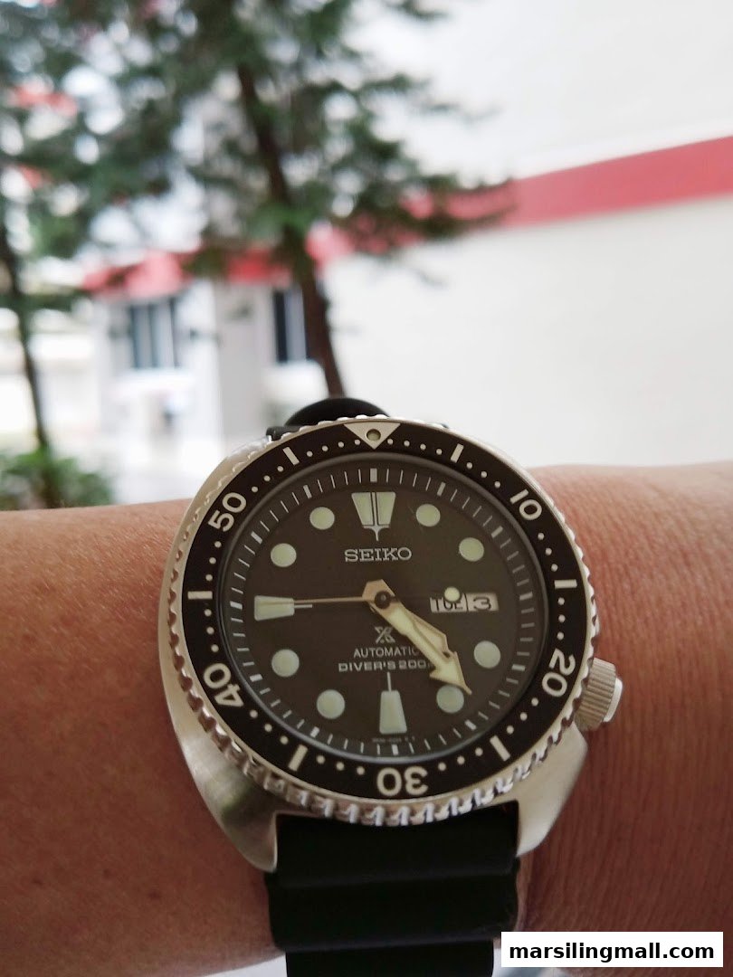 A close-up of a Seiko automatic diver's watch worn on a wrist.