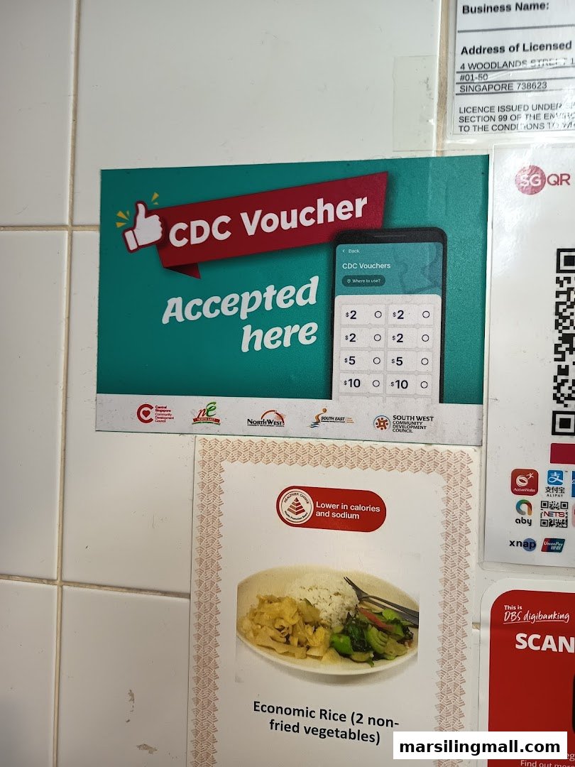 Signs promoting CDC voucher acceptance and a healthy economic rice option at Shan Xing Zhai.