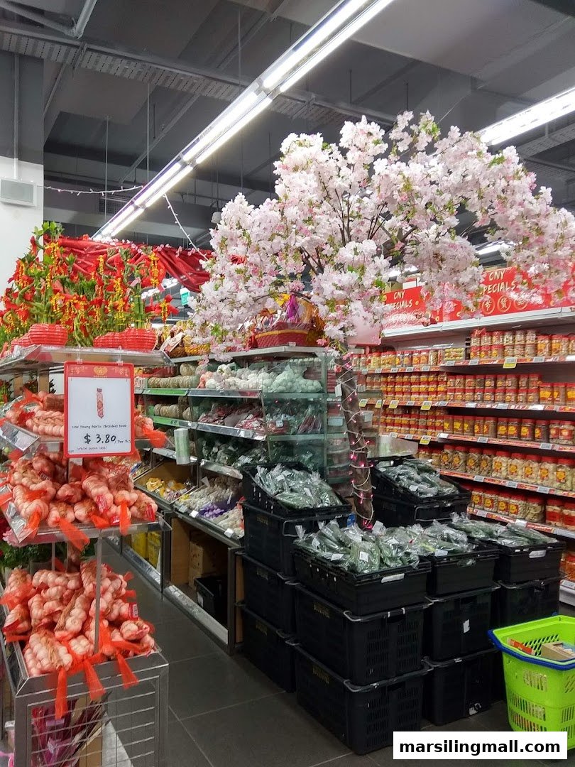 A supermarket aisle decorated with cherry blossoms and festive items, featuring fresh produce and packaged goods.