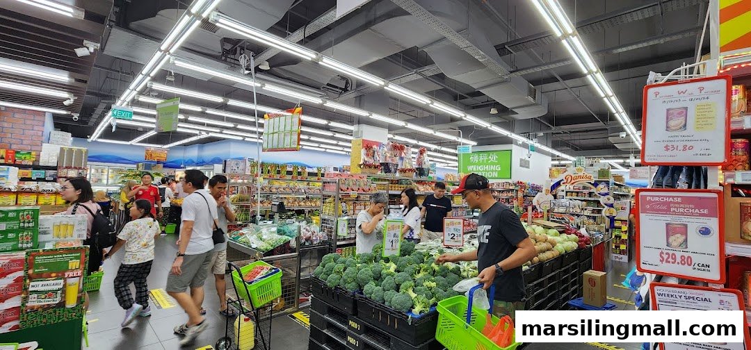 Customers shop for fresh produce and groceries in a brightly lit Sheng Siong Supermarket aisle.