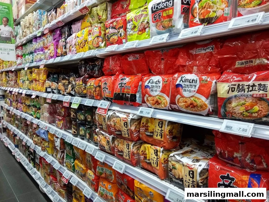 An aisle in Sheng Siong Supermarket displaying a wide variety of instant noodles and packaged foods.