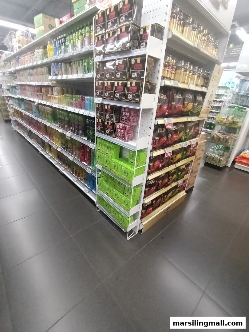 An aisle in Sheng Siong Supermarket displaying various packaged goods and beverages.