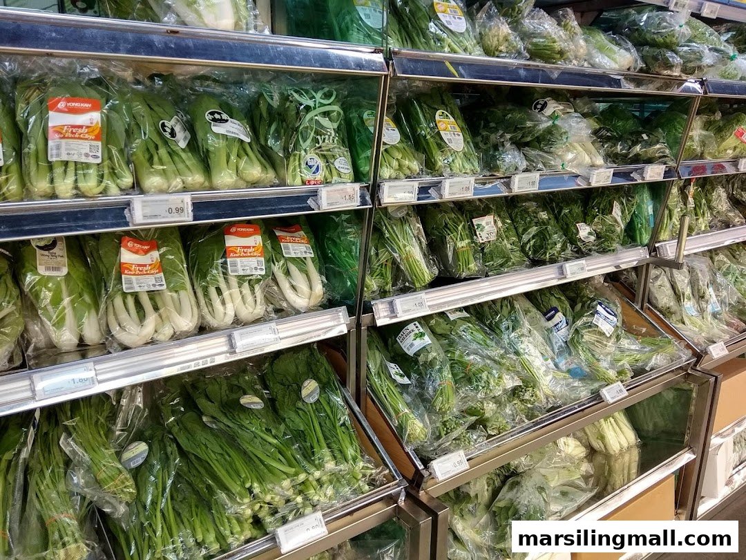 Shelves filled with various fresh, pre-packaged vegetables in a supermarket.