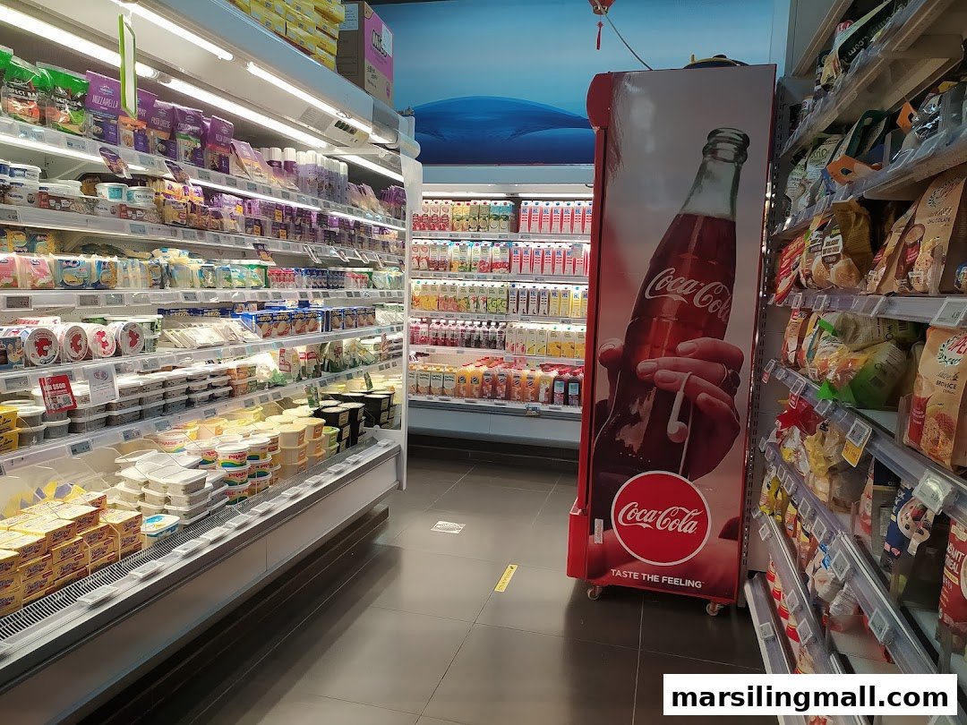 Interior view of a Sheng Siong Supermarket aisle featuring refrigerated goods, beverages, and packaged foods.