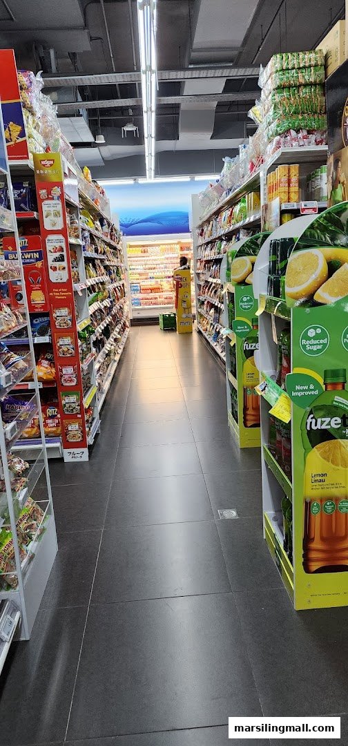 A brightly lit aisle inside Sheng Siong Supermarket, showcasing various packaged goods and beverages.