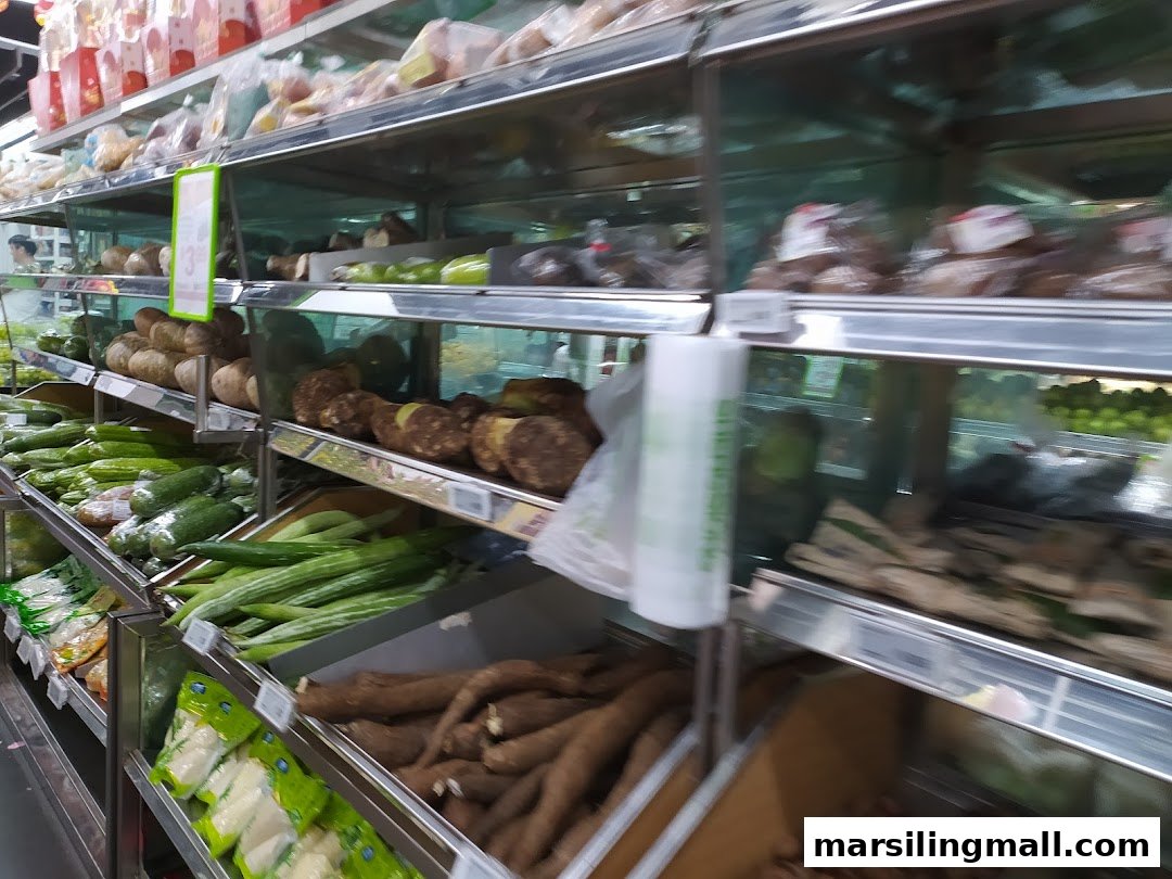 Shelves filled with a variety of fresh vegetables and root crops in a supermarket.