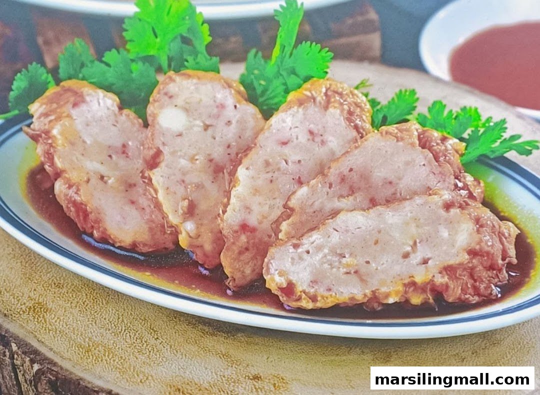 Close-up of sliced meatloaf or ngoh hiang served with sauce and fresh cilantro.