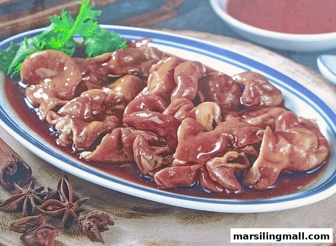 A plate of braised pig intestines in a rich, savory sauce, garnished with fresh herbs and star anise.
