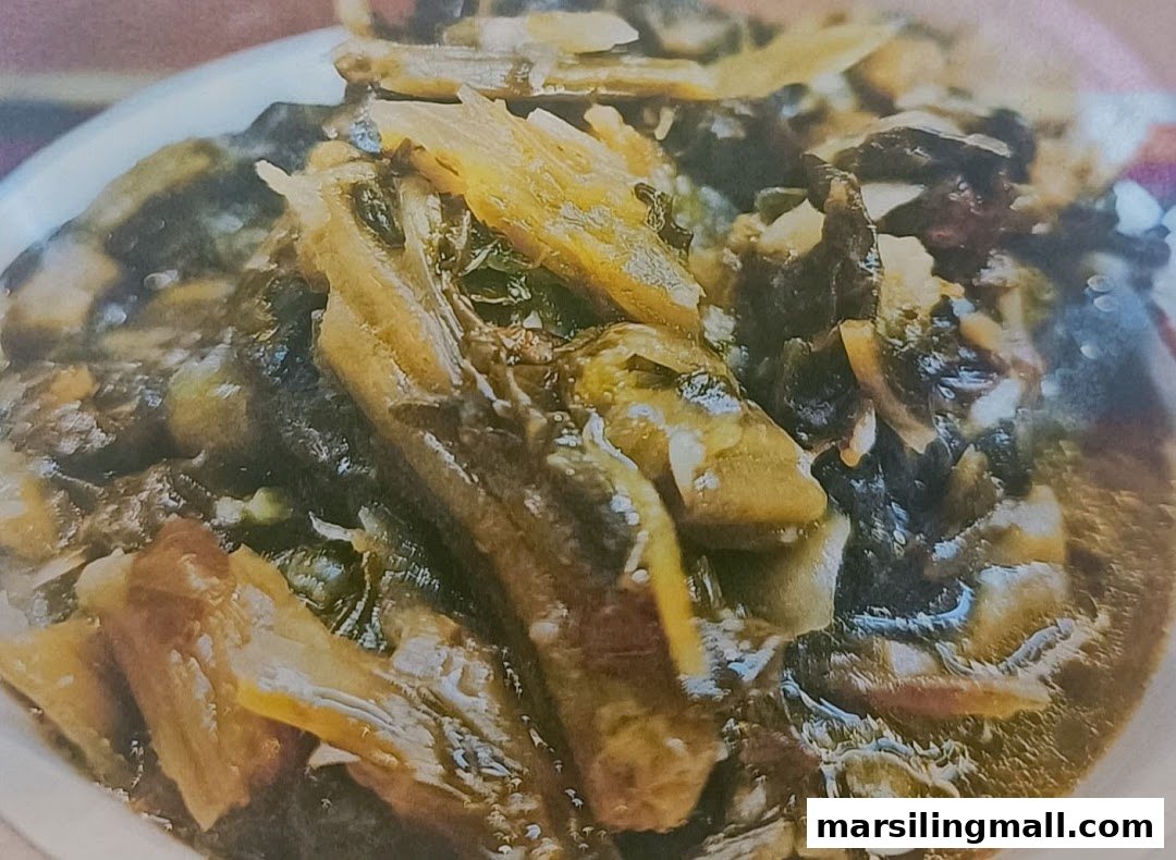 A close-up of a savory, dark braised dish with vegetables in a white bowl.
