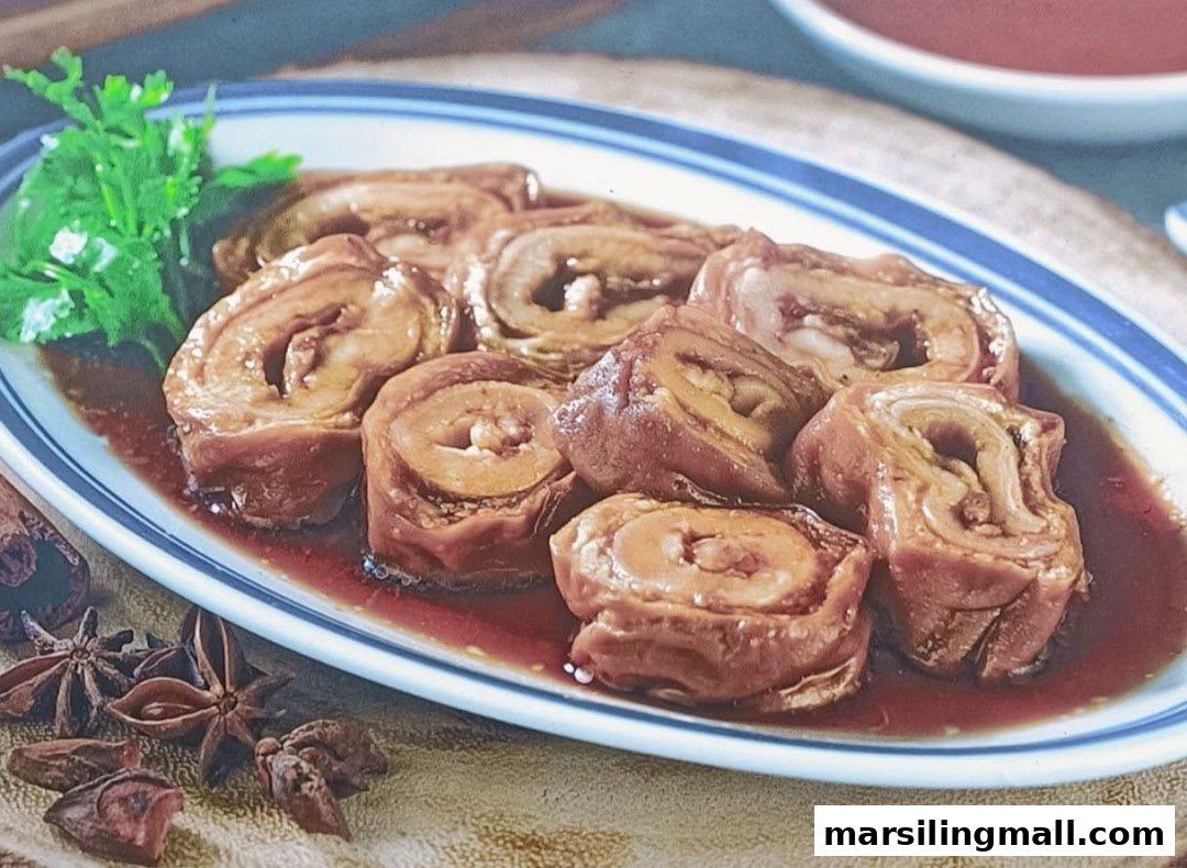 A plate of braised pig intestines garnished with cilantro and star anise.
