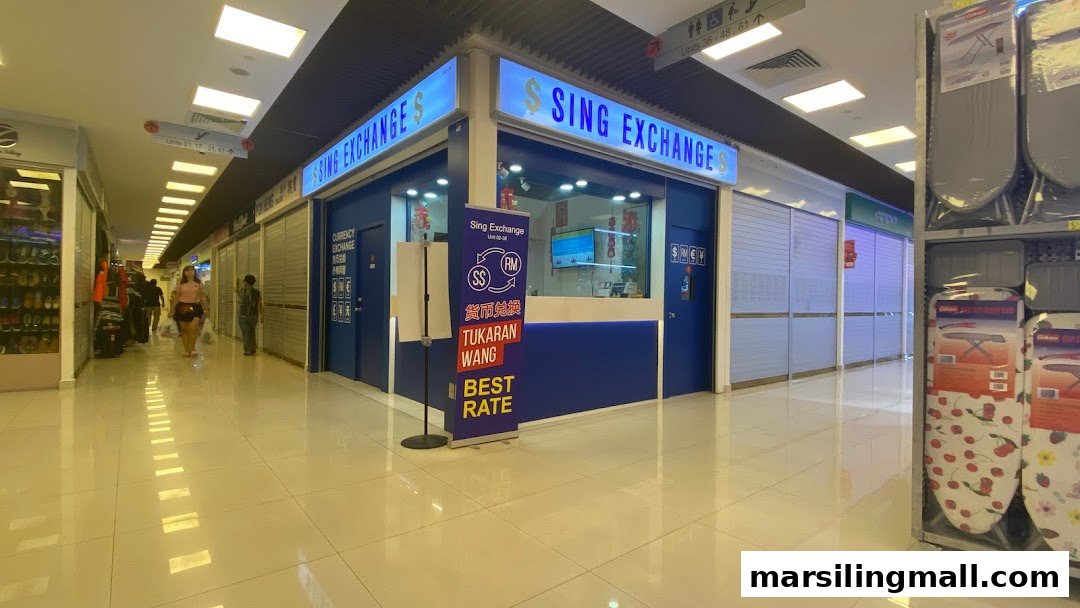 The image displays the brightly lit storefront of Sing Exchange Money Changer within a shopping mall.