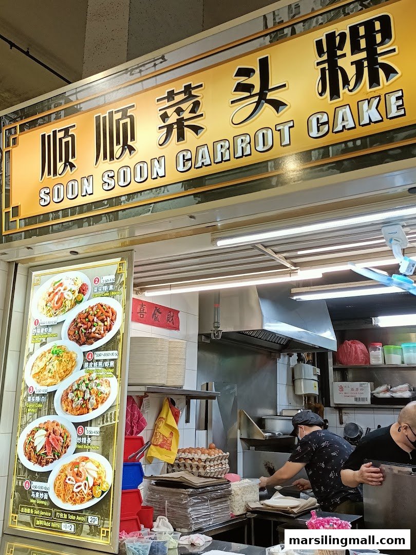 A bustling hawker stall, Soon Soon Carrot Cake, with its menu board and chefs at work.