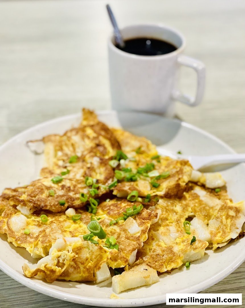 A plate of fried carrot cake with spring onions and a cup of black coffee.