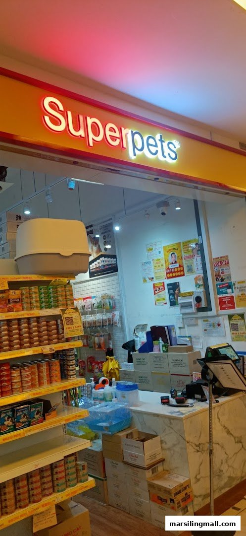 The image shows the brightly lit entrance of Superpets pet store, featuring shelves stocked with pet food and supplies.