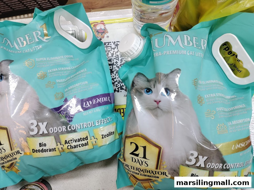 Two large bags of Lumber Ultra-Premium Cat Litter, highlighting odor control and clumping features.