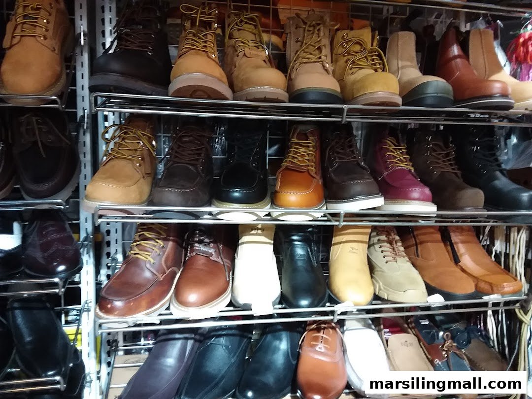 Shelves filled with a diverse collection of men's boots and shoes in various styles and colors.