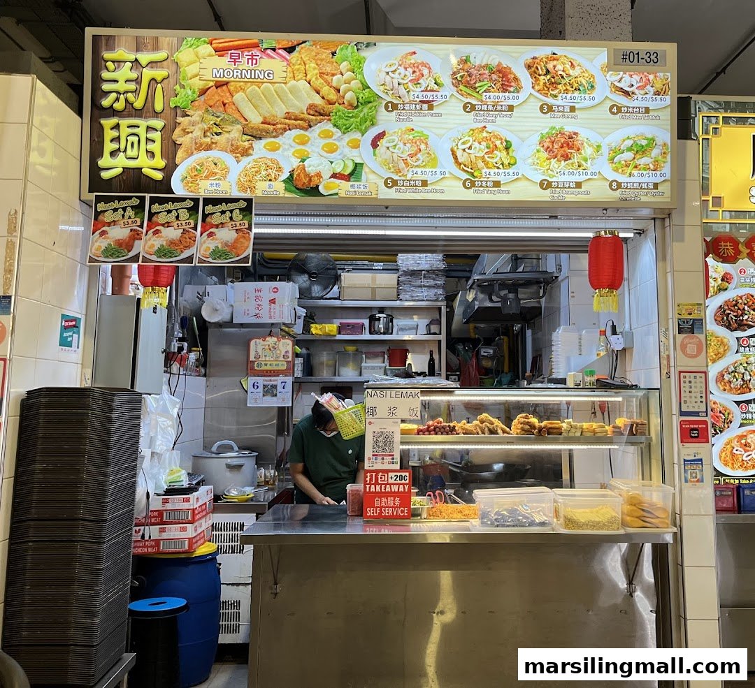 A hawker stall named Xin Xing with a large menu board displaying various local dishes and prices.