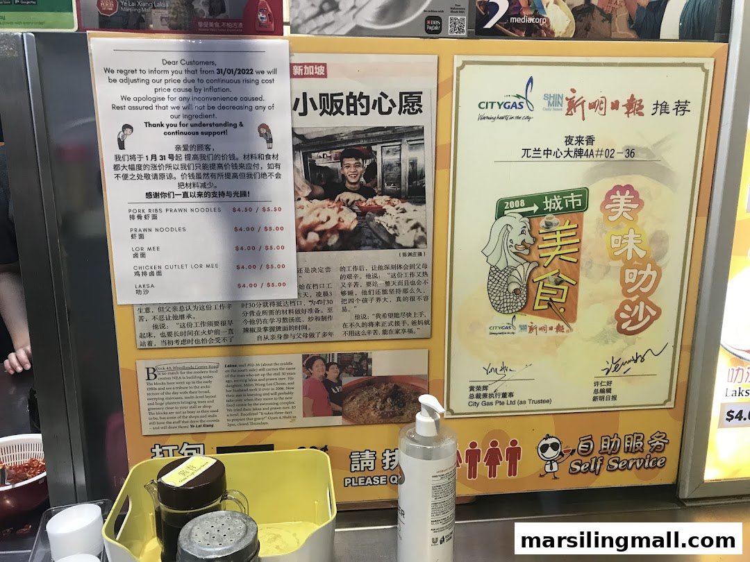 A food stall's display board featuring menu items, prices, a price adjustment notice, and promotional articles.