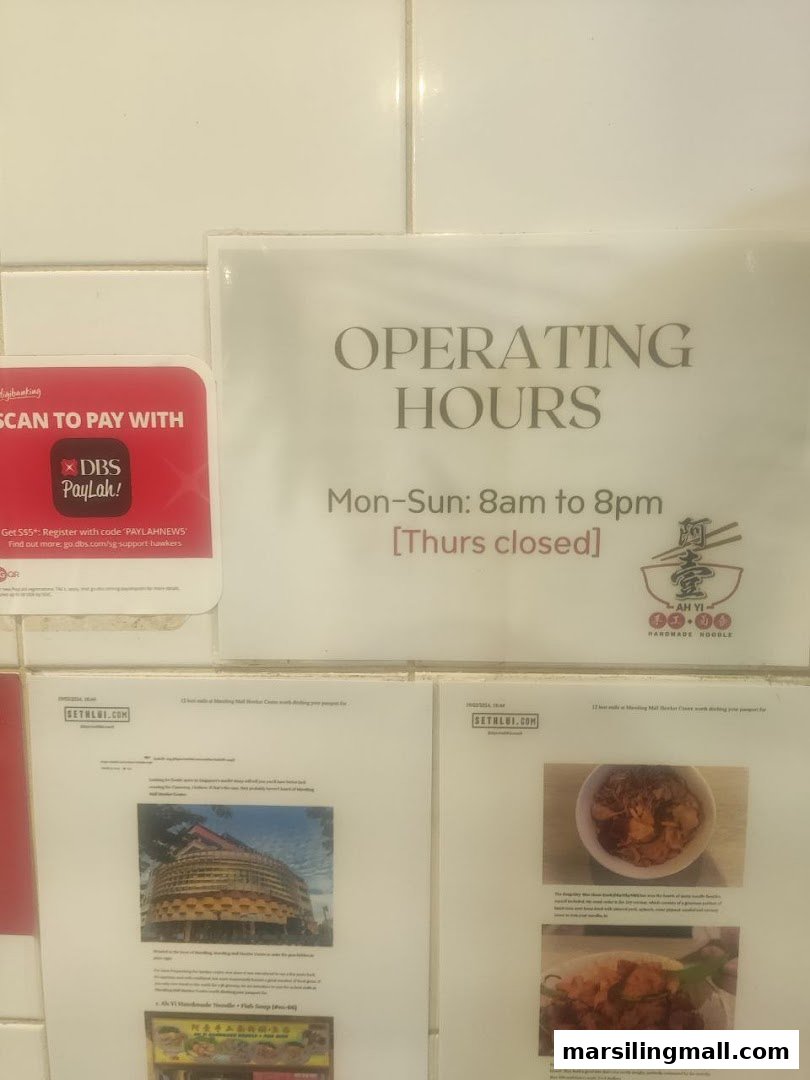 Operating hours, payment options, and customer reviews displayed on a wall for the noodle shop.