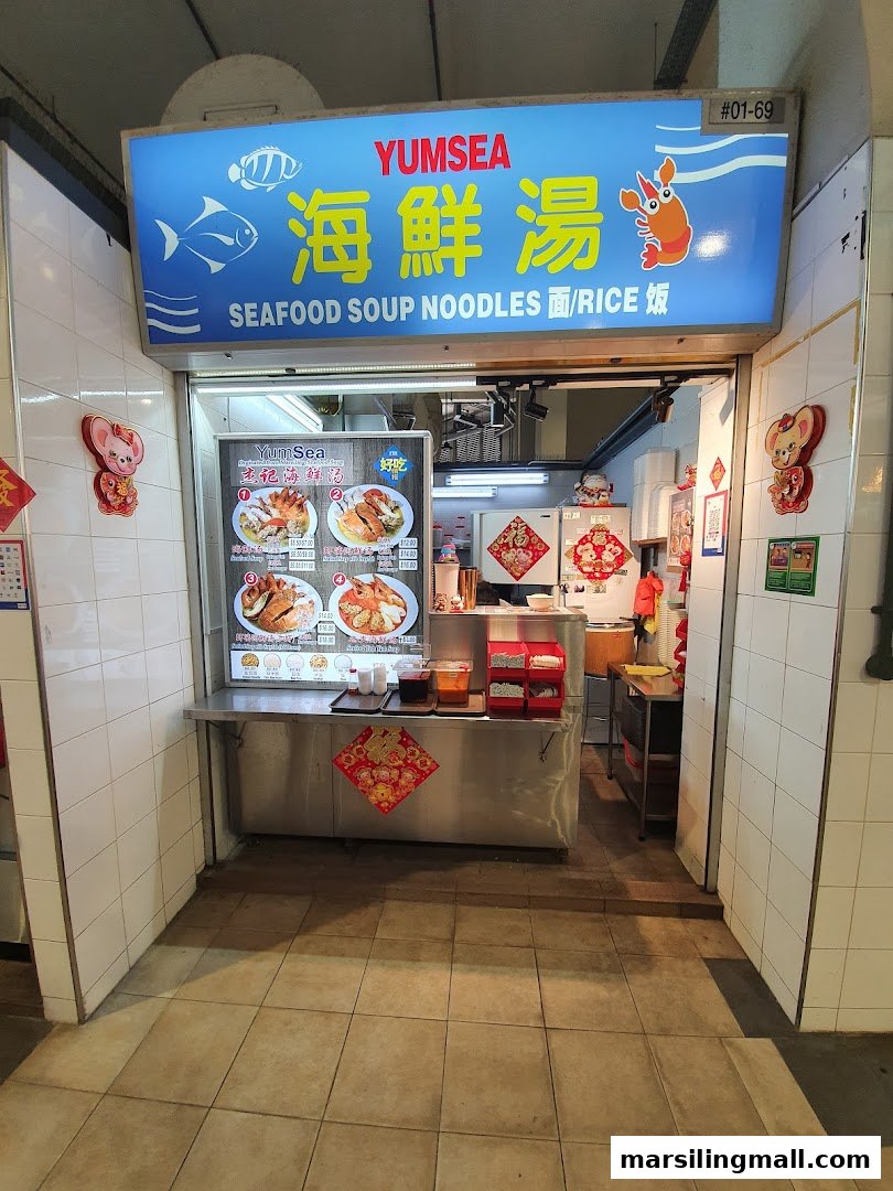 Front view of YumSea Seafood Soup stall with its signboard and menu display.