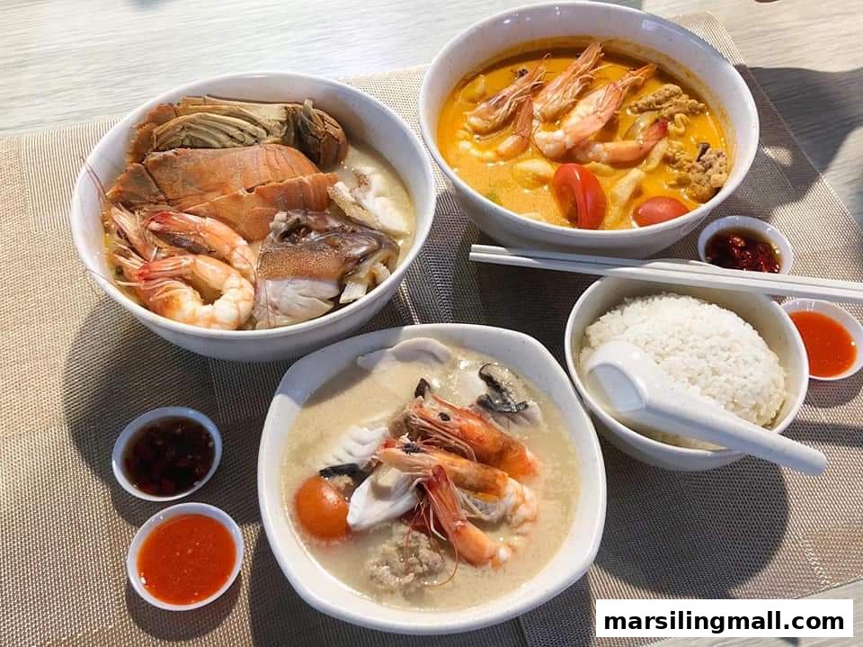 Three bowls of delicious seafood soup with various fresh ingredients, served with rice and sauces.