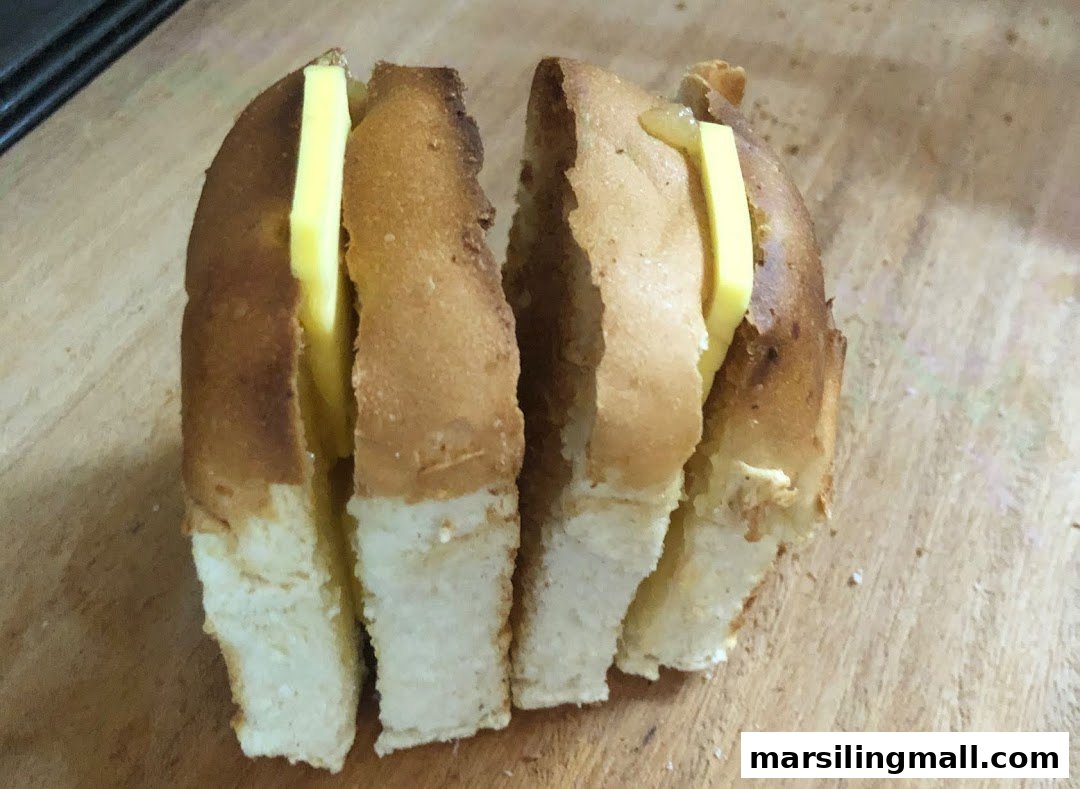 Close-up of toasted bread with thick slices of butter and kaya, cut into four pieces.