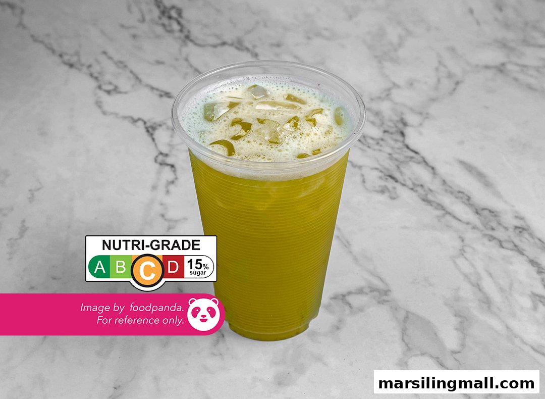 A refreshing green drink with ice in a clear cup, featuring a Nutri-Grade C label with 15% sugar.