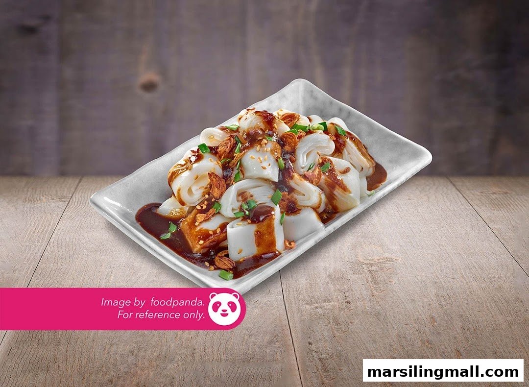 A plate of savory rice rolls (Chee Cheong Fun) with dark sauce, crispy toppings, and spring onions.