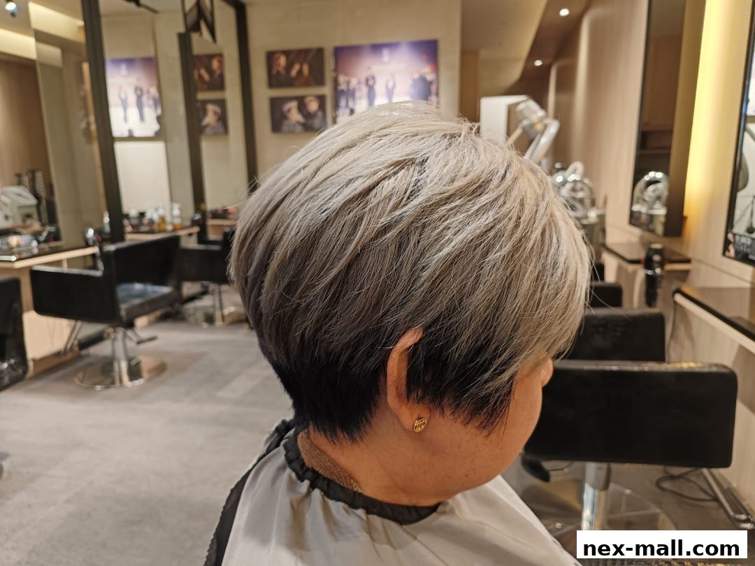 A person with a stylish blonde and black ombre haircut in a modern hair salon.
