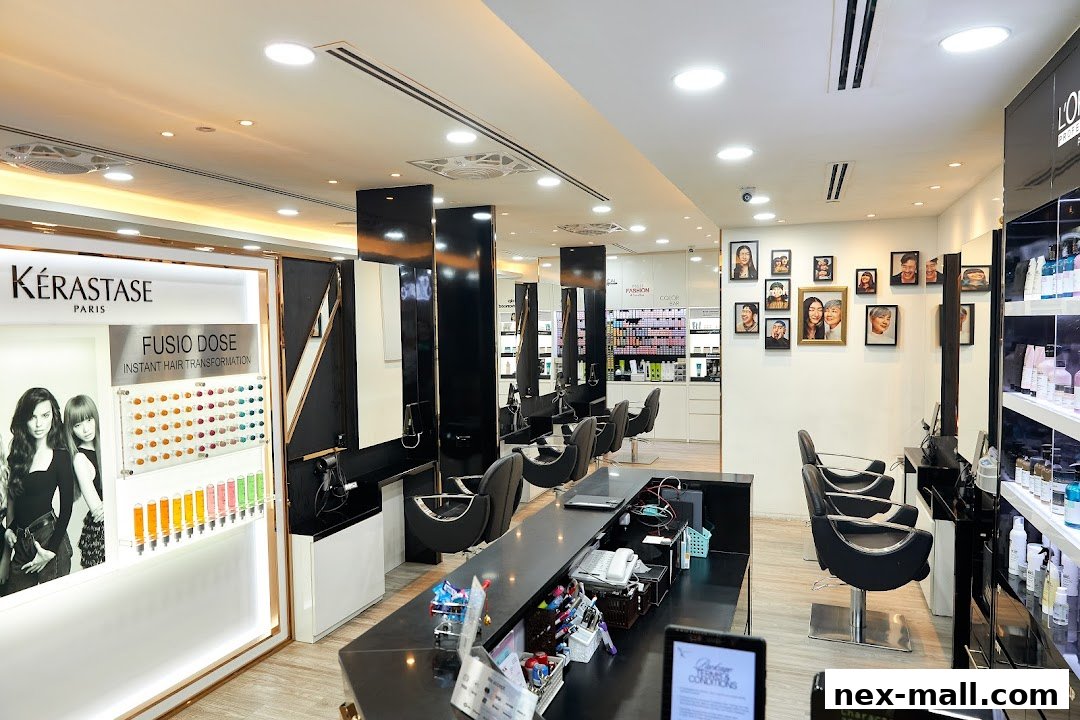 Interior view of a modern hair salon with styling chairs, mirrors, and Kerastase products.