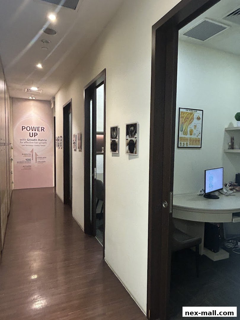 A hallway inside Beijing 101 Hair Consultants Nex with treatment rooms and a poster about hair growth.
